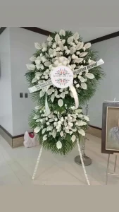 A two-tier White sympathy floral display by Flower Bar Cebu