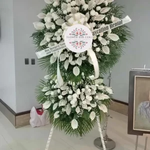 A two-tier White sympathy floral display by Flower Bar Cebu