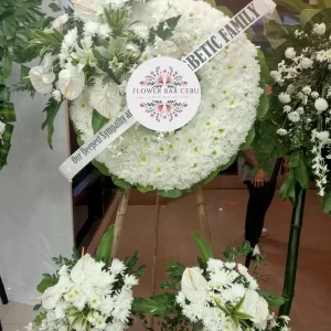 A Classic White Funeral Wreath with Coordinating Base Sprays by Flower Bar Cebu