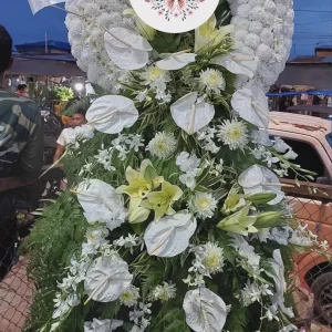 A white wreath sympathy stand by Flower Bar Cebu